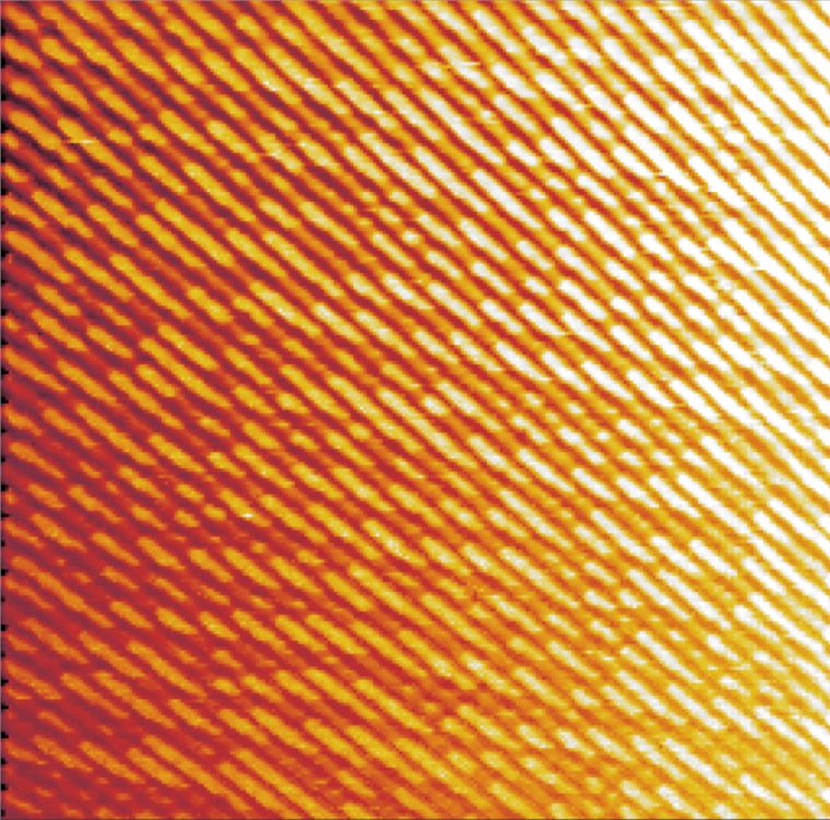 Atomic force microscope scan of a DVD RW disc, showing regular parallel data tracks made up of short recorded marks.